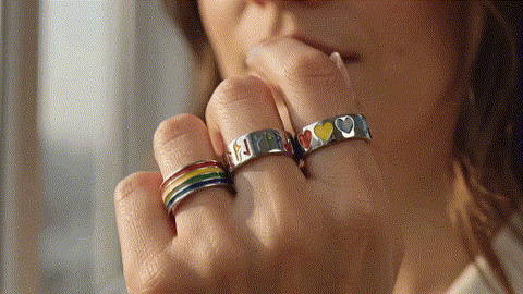 Someone wearing Pride accessories in their flag's colors