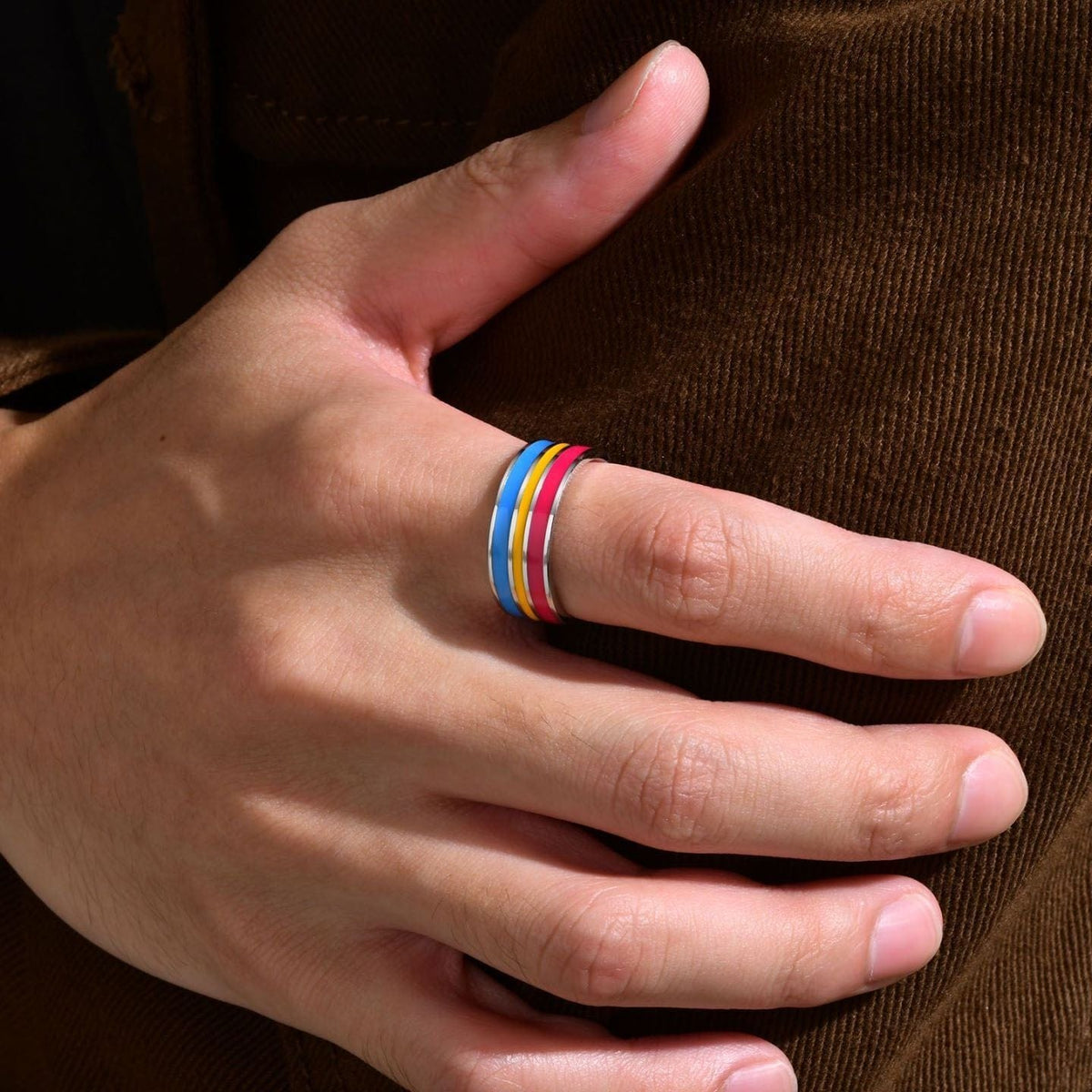 Pansexual Pride Ring worn on a hand