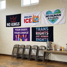 All five Full Resistance Flag Pack flags hung on a community hall wall