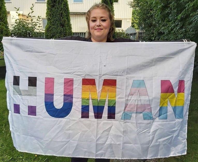 Customer photo with the We're All Human Flag